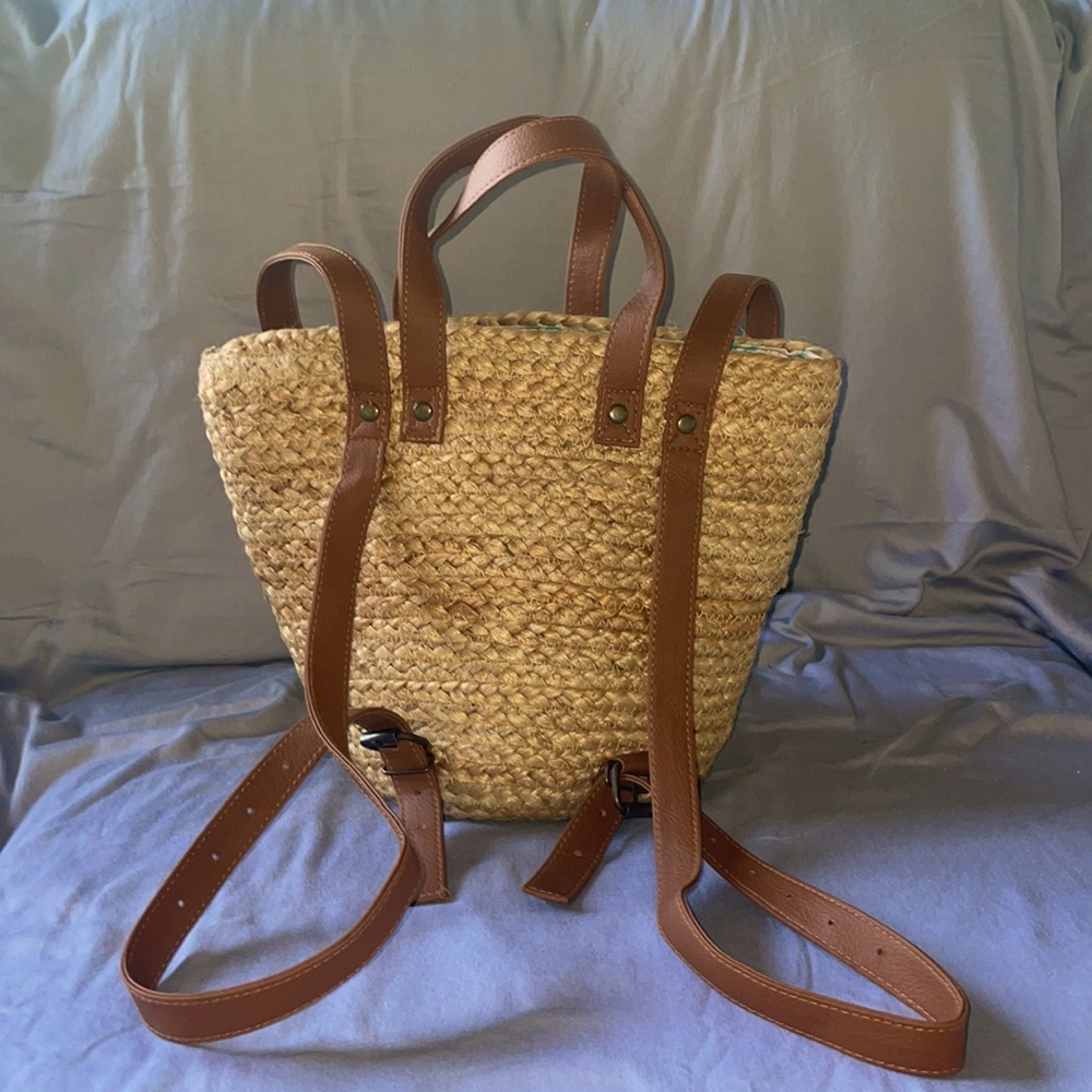 NWOT. Never been used. Woven straw backpack tote. Perfect for summer outings!